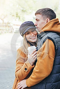 Happy young couple in love teenagers friends dressed in casual style walking together on city street in cold season