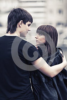 Happy young couple in love walking in city street