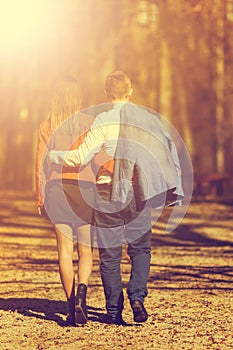 Happy young couple in love walking in the park in autumn