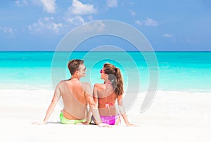 Happy young couple lying on a tropical beach in Cuba