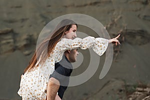 Happy young couple. Man piggybacking his girlfriend in summer