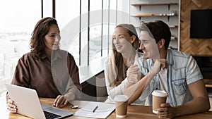 Happy young couple meeting with real estate agent in office