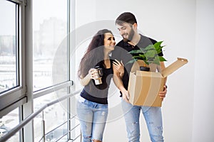 Happy young couple moving in new home unpacking boxes