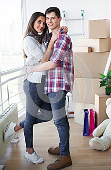Happy young couple moving together in new apartment