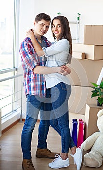 Happy young couple moving together in new apartment