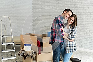 Happy young couple moving together in new apartment.