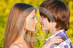 Happy young couple outdoors in field. Relationships