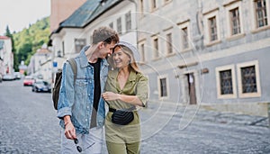 Happy young couple outdoors on street on town trip, walking and talking.