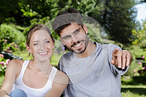 happy young couple in park relaxing after picnic