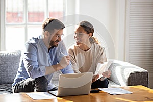 Happy young couple pay bills using online banking