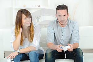 happy young couple playing video games