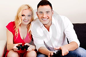 Happy young couple playing video games