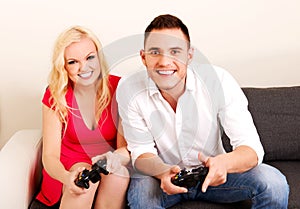 Happy young couple playing video games