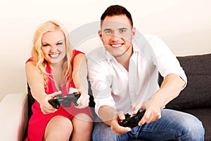 Happy young couple playing video games