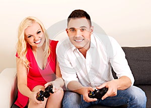 Happy young couple playing video games