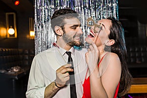 Happy young couple posing together at nightclub