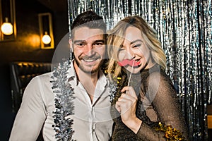 Happy young couple posing together at nightclub