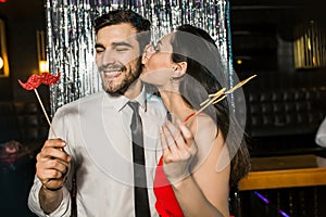 Happy young couple posing together at nightclub