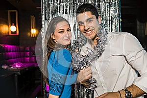 Happy young couple posing together at nightclub