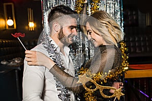 Happy young couple posing together at nightclub