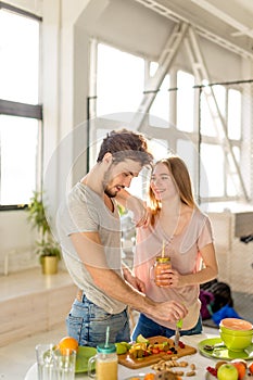 Happy young couple prepares a healthy drink