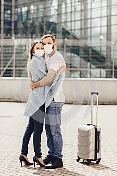 Happy young couple in protective masks. Concept of travel, airplane flights