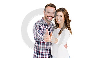 Happy young couple putting thumbs up