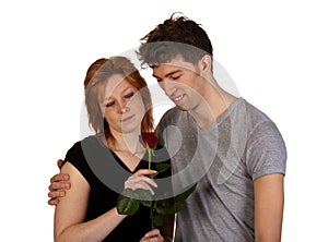 Happy young couple with red rose