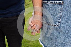 Happy young couple rejoices in buying an apartment, the couple holds in their hands the keys to their new home. Buying a home