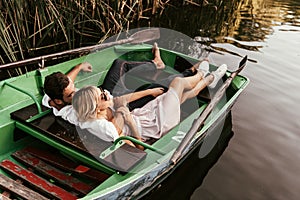 happy young couple relaxing in boat