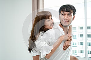 Happy young couple relaxing in the home bedroom.