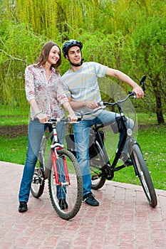 Happy young couple riding bicycles