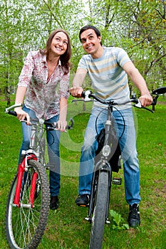 Happy young couple riding bicycles