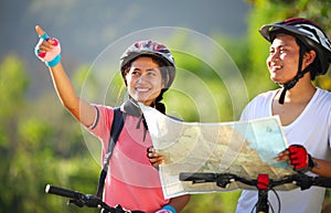 Happy young couple riding a bike