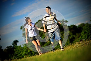 Happy young couple running outdoor