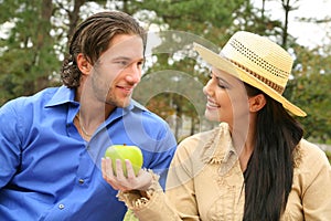 Happy Young Couple Sharing Fruits