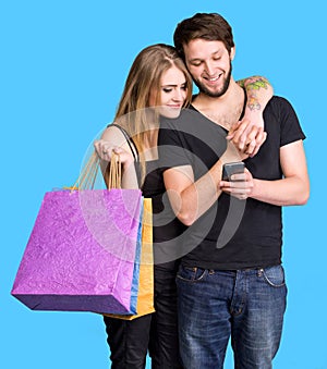 Happy young couple with shopping bags