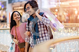 Happy young couple in shopping mall