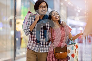 Happy young couple in shopping mall