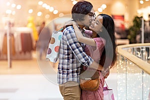 Happy young couple in shopping mall