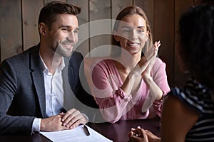 Happy young couple sign contract buy real estate property