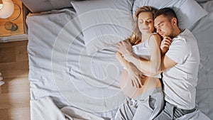 Happy Young Couple Sleeping Together in the Bed, Sweet Loving Young People Holding Each other whil