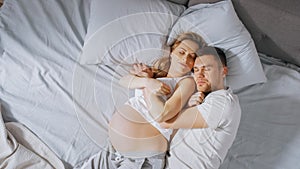 Happy Young Couple Sleeping Together in the Bed, Sweet Loving Young People Holding Each other whil