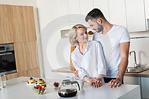 happy young couple smiling each other while having