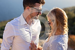 Happy young couple smiling in sunset together