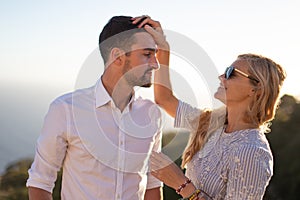 Happy young couple smiling in sunset together