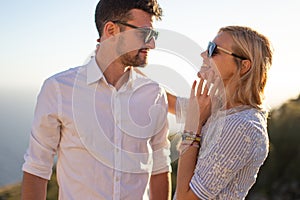 Happy young couple smiling in sunset together