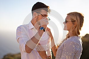 Happy young couple smiling in sunset together