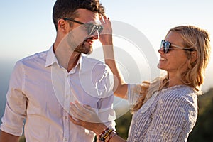 Happy young couple smiling in sunset together