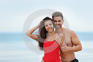 Happy young couple spending time  on beach